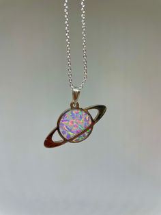 "Planet shaped necklace made with rainbow crushed opal and resin. On a 925 silver 22\" chain, and a 925 bail" Iridescent Sterling Silver Round Jewelry, Iridescent Round Sterling Silver Jewelry, Mystical Silver Jewelry Gift, Mystical Sterling Silver Necklace For Gift, Mystical Silver Jewelry For Gifts, Hypoallergenic Sterling Silver Iridescent Jewelry, Hypoallergenic Iridescent Sterling Silver Jewelry, Magical Silver Charm Necklaces As Gift, Magical Silver Charm Necklaces For Gift