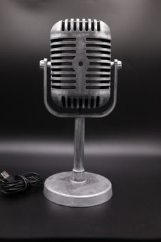 an old fashioned microphone sitting on top of a table