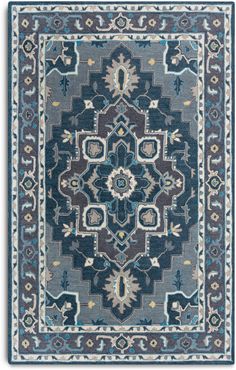 a blue and brown rug with an intricate design on the center, in front of a white background