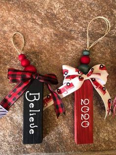 three christmas ornaments are hanging on the wall