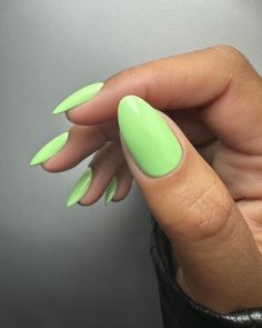 a woman's hand with bright green nails