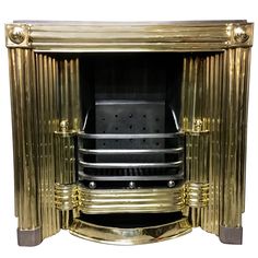 a gold colored fireplace with black and silver accents