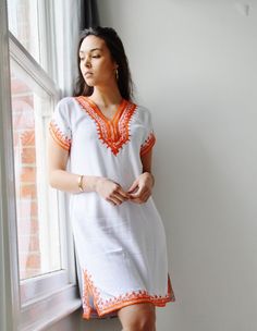 ooooooooooooooooooooooo A great spring/summer piece from Maison de Marrakech. We have combined the unique Moroccan embroidery technique into our own 'bohemian romantic' designs. It's stunning on its own, or you can wear this beauty with boho accessories, or simple elegant accessories, and will look just FAB. It's elegant, yet casual, not to mention the exotic embroidery, which brings out the uniqueness of this beautiful tunic dress. Wow your friends this summer, it's 100% handmade, and cannot be Orange Tunic Dress, Ethiopian Clothing, Moroccan Clothing, Moroccan Dress, Holiday Wear, Autumn Dress, African Design Dresses, Tunic Styles, African Dress