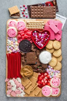 a tray filled with lots of different types of cookies and other food on top of it