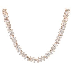 Elegant and alluring, this diamond tennis statement necklace features prong set Baguette Cut shimmering white diamonds weighing 13.10 carats in total. Diamond quality: G-H color and VS-SI clarity. Crafted in fine 18k yellow gold. The necklace is secured by a hinged locking clasp. Length: 16 inches. Width: 5 mm. Total diamonds: 235. Total weight: 27.54 grams. Comes with a presentable gift box and appraisal. Luxury Refined Baguette Cut Jewelry, Luxury Diamond Necklace With Baguette Diamonds, Elegant Luxury Necklace With Baguette Diamonds, Luxury Baguette Diamond Necklace, Luxury Baguette Diamond Necklace For Formal Events, Luxury Baguette Cut Necklace Gift, Luxury Fine Jewelry Tennis Necklace With Baguette Diamonds, Luxury Modern Baguette Cut Necklace, Luxury Baguette Cut Tennis Necklace