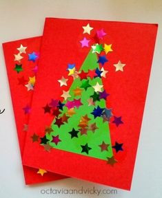 two red cards with stars on them and a christmas tree cut out from the bottom