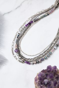 Experience the beauty and versatility of the Reflections Collection. Each piece is thoughtfully handcrafted using carefully chosen materials. This multistrand necklace measures 17.5-19.5" and is completed an antique silver plated brass extender chain and lobster claw clasp. Elevate your style with Reflections. Antique Silver Plated Brass (lead and nickel free) Amethyst, Czech Glass, Pearl 17.5-19.5", adjustable with antique silver plated brass lobster claw clasp We hand select our natural materi Bohemian Sterling Silver Necklaces For Layering, Silver Bohemian Beaded Necklaces For Layering, Silver Necklaces With Natural Stones For Layering, Silver Gemstone Necklace For Layering, Silver Multi-strand Beaded Necklaces With Natural Stones, Silver Multi-strand Necklace With Natural Stones, Handmade Silver Necklaces For Layering, Bohemian Multi-strand Silver Crystal Necklaces, Bohemian Silver Multi-strand Crystal Necklaces