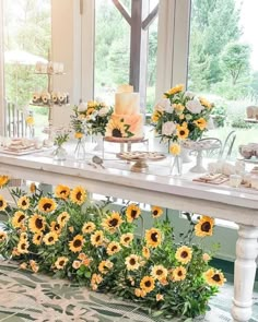 a table with sunflowers and candles on it