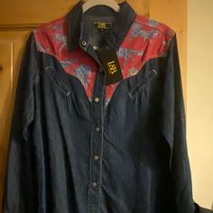 Lightweight Denim With Horse Motif Yoke Dark Wash Cotton Tops For Rodeo, Blue Shirt For Spring Rodeo, Blue Shirt For Rodeo In Spring, Western Style Blue Tops For Spring, Denim Blue Tops For Rodeo, Blue Summer Shirt For Rodeo, Blue Shirt For Summer Rodeo, Blue Shirt For Rodeo In Summer, Denim Blue Long Sleeve Top For Rodeo