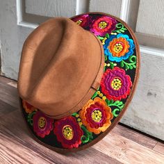 Stand out with this beautiful handcrafted Mexican Suede Hat with beautiful detailed floral embroidered canvas brim. Perfect accessory to add that with that daily outfit. MADE IN MEXICO By: Mexican Artisans For: Women Size: Medium 23' Color: brown | black | multi Details: Top Suede Embroidered canvas brim Inner elastic band Contact us for more details PLEASE READ BEFORE PURCHASE: The picture is an ACCURATE REPRESENTATION.Colors in the pictures may vary a little by effects of light. Each product i Mexican Flower Hat, Mexican Inspired Clothing, Mexican Hats For Women, Embroidered Brown Cap, Brown Embroidered Hat, One Size, Hippie Multicolor Spring Hat, Hippie Spring Hats With Adjustable Fit, Hippie Spring Hats Adjustable Fit, Bohemian Brown Felt Hat For Summer