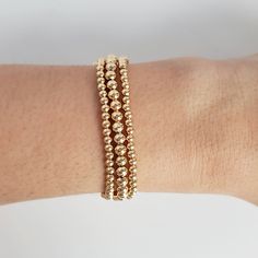 A classic gold bead bracelet is a perfect addition to a dainty stack. The beads are strung on a premium stretch cord.SOLD BY SET OF 3 BRACELETSDETAILS:- 18K gold plated brass beads made to last- round bead size: 1x4mm, 1x3mm, 1xRainbow Pearl Everyday Hand-strung Beaded Bracelets In 14k Gold, Everyday 14k Gold Hand-strung Beaded Bracelets, Elegant Adjustable 14k Gold-filled Beaded Bracelet, Elegant Hypoallergenic Rosary Bracelet With Round Beads, Classic Gold Beaded Bracelets In 14k Gold Filled, Classic Gold Beaded Stretch Bracelet, Classic 14k Gold Filled Bracelets With Gold Beads, Classic 14k Gold-filled Bracelets With Gold Beads, Elegant Rose Gold Stretch Bracelet For Daily Wear