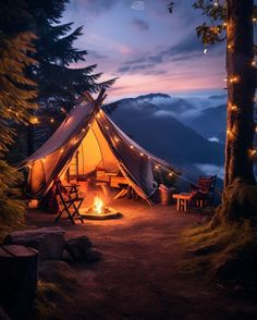 a tent is lit up at night in the woods