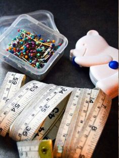 measuring tape, scissors and other craft supplies on a table