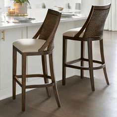 two stools in the middle of a kitchen