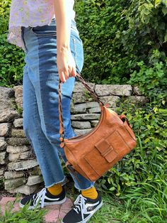 "Beautiful dark brown shoulder bag with in a very retro style that goes very well with jeans or a dress, or...  Talk about casual, with class! And do not even let them start talking about the super eclectic braided strap because you will not hear the end of it! Condition:  Pre-owned. Excellent condition, no tears, no scratches, no signs of wear, very clean! Material: Leather, lining appears to be canvas. Color: Caramel Brown. Dimensions: Approx., 7.5\" tall, 11.\" wide, base: 4\" Strap Character Brown Leather Shoulder Bag, Brown Shoulder Bag, Caramel Brown, Braided Strap, Brown Canvas, Leather Zipper, Braided Leather, Retro Style, Purses And Handbags