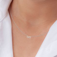 "Symbolising eternity, purity and everlasting love, this silver infinity necklace from Little Silver is the perfect way to commemorate a special milestone in your friendship. Hand-crafted in genuine 925 sterling silver, each looping pendant floats elegantly from a 16\" (+2inch extender) necklace chain with a spring ring closure. Cubic zirconia pavé settings add a beautiful dimension of sparkle and texture to the appearance of this infinity chain necklace. Elegantly displayed in a gift-ready embossed  box with our brand name \"Little Silver'' in silver foil lettering, this piece makes a thoughtful and timeless necklace gift for women. Present this eternity necklace as an unforgettable gift for her for Christmas, Mother's Day, Birthdays, Anniversaries or \"just because\"." Silver Infinity Necklace, Infinity Chain, Infinity Necklace Silver, Friendship Necklace, Infinity Knot, Infinity Pendant, Friendship Necklaces, Infinity Necklace, Jewellery Gift