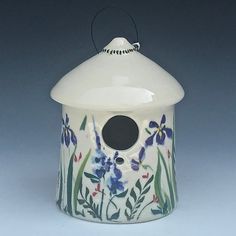 a bird house with flowers painted on it