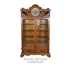 an antique wooden bookcase with glass doors