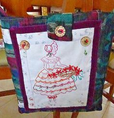 a handmade tote bag sitting on top of a wooden table next to a chair