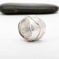 This "Odin" silver ring is handmade in Fine Silver (99.9% pure silver). This unique piece is entirely molded by hand, using the silver clay technique. The style of this ring is inspired by the Vikings and the Old Norse mythology. Ring size: 7.5 (This is a unique creation. Only one size available. I cannot adjust the ring size.) What is Fine Silver? Fine Silver, also called Precious Metal Clay or Silver Clay, is a malleable material composed of microscopic particles of pure silver. It is made fro Silver Wide Band Hand Cast Ring, Silver Wide Band Ring Hand Cast, Unique Hand Cast Silver Rings, Unique Hand-cast Silver Rings, Artisan Sterling Silver Wide Band Ring, Artisan Hand Cast Silver Rings, Artisan Hand Cast Round Rings, Hand Cast Sterling Silver Wide Band Jewelry, Hand Cast Wide Band Jewelry Gift