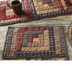 two placemats and a coffee cup on a wooden table