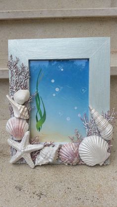 an ocean scene with shells and seaweed is displayed in front of a blue frame