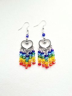 These rainbow heart earrings are handmade. These filigree chandelier earrings can be worn for a party, festival, carnival or beach these earrings can be given as a birthday gift, gift for daughter, neice, or a gift for her. Suitable for gift for wife or girlfriend. These long heart chandelier dangle drop earrings, are made with a filigree heart connecter, multi colored  pearl beads , the earwire is silver plated. They are 3.5 inches long including earwire. The short chandelier earrings are made Summer Gift Rainbow Earrings, Rainbow Dangle Earrings For Summer, Summer Rainbow Jewelry With Dangling Beads, Handmade Rainbow Earrings For Summer, Rainbow Dangle Earrings With Ear Wire, Handmade Rainbow Drop Earrings, Bohemian Rainbow Drop Earrings Jewelry, Handmade Rainbow Jewelry For Summer, Rainbow Party Jewelry With Dangling Beads