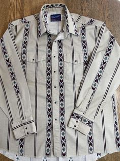 Vintage Wrangler Shirt 18 x36 X Long Tails Cowboy Cut Western Aztec Made in USA. Neutral Aztec Western print. Snap front all present and tight. No visible flaws. Collar shows slight discoloration please see photo. Refer to photos for measurements and to insure fit prior to purchase. Freshly laundered and pressed from smoke free pet free home. Western Style Long Sleeve Cotton Shirt, Relaxed Fit Cotton Shirt For Ranch, Western Style Long Sleeve Relaxed Fit Shirt, Western Style Long Sleeve Relaxed Shirt, Western Cotton Shirt With Pockets, Western Style Cotton Shirt With Pockets, Relaxed Fit Cotton Shirt For Rodeo, Aztec Shirt, Wrangler Vintage