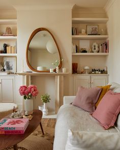 a living room filled with furniture and a mirror