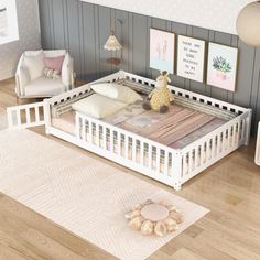 a baby's room with a white crib and wooden floors