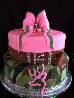 a three tiered cake with pink and brown decorations