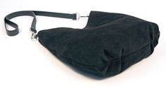 "This beautiful and luxuriously soft suede hobo bag will be a fashionable and chic addition to any ensemble. Crafted from a premium calf suede and fully lined with cotton canvas. This bag also features (2) interior 7\" zipper pockets, crossbody or shoulder strap, snap closure, pleats on bottom, silver hardware and hand painted edges. Handmade in Denver, CO. USA Dimensions: Width at widest- 14\" Height at tallest- 13\" Weight- 1 lb. 9 oz. Not finding exactly what you want? Sean Ray can make it fo Elegant Hobo Shoulder Bag With Suede Lining, Modern Leather Hobo Bag With Suede Lining, Luxury Suede Hobo Bag With Soft Leather, Elegant Suede Lined Hobo Shoulder Bag, Luxury Suede Hobo Bag, Chic Suede Bucket Bag With Suede Lining, Evening Suede Hobo Bag With Soft Leather, Evening Suede Bags With Leather Handles, Modern Rectangular Suede Hobo Bag