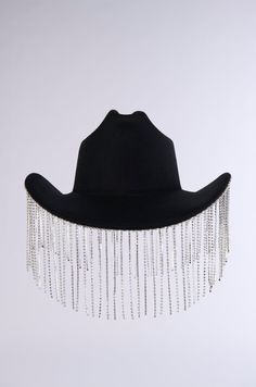 Get rambunctious at the rodeo in The AKIRA Label Lets Get Rowdy Bling Cowboy Hat. This glamorous Western accessory features a felt-like base, a tall dimpled crown, a classic upturned brim, faux silver metallic hardware, and sparkling rhinestone link fringe along the brim’s perimeter. Style with faux leather chaps and a sleek corset for a festival-ready ensemble.  - 65% Cotton 35% Polyester (all measurements are approximate from size O/S) - 22” Head Circumference, 44” Outer Brim Circumference  - 4.75” Fringe Length  - Imported Product ID: 394562 Leather Chaps, Western Accessories, Cowboy Hat, Head Circumference, Cowboy Hats, Metallic Silver, Cowboy, Faux Leather, Felt