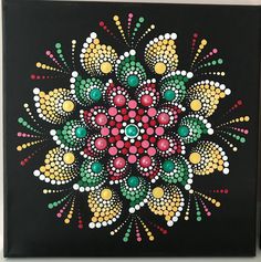 a painting on a black wall with colorful dots and circles in the shape of a flower