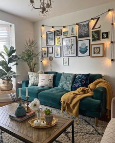 a living room filled with lots of furniture and pictures on the wall above it's coffee table