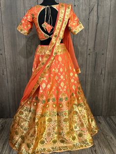 Gorgeous peach and gold Banarsi Lehenga set.  Includes * kalidar lehenga finely stitched with lining and finished with latkans. *  designer padded blouse, with extra stitches to go up a couple sizes. * chiffon dupatta with Banarsi border. Orange Dola Silk Lehenga For Festivals, Fitted Peach Traditional Wear With Zari Work, Orange Dola Silk Lehenga, Orange Anarkali Choli In Dola Silk, Orange Zari Work Sets For Wedding, Orange Anarkali Lehenga In Dola Silk, Anarkali Orange Dola Silk Lehenga, Traditional Peach Wear With Zari Work In Traditional Drape, Traditional Semi-stitched Peach Choli