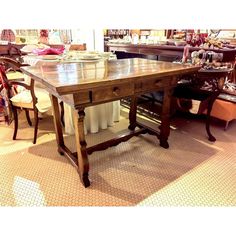 a wooden table sitting inside of a store