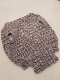 a knitted sweater with holes in the middle