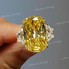 Handmade 22.3 TCW Three stone cushion cut moissanite engagement ring,trapezoid&big yellow elongated cushion three stone moissanite ring,wedding ring,celebrity style ring → Occasions: Engagement & Wedding DESCRIPTION  -------------------- STYLE                :Three stone  ●𝐂𝐞𝐧𝐭𝐞𝐫 𝐒𝐭𝐨𝐧𝐞 𝐃𝐞𝐭𝐚𝐢𝐥𝐬 →Stone Type      :Moissanite - High Quality →Main Stone      :Cushion (Canary Yellow) →Size (mm)        :19*12 →Carat Weight   :20  ●𝐌𝐚𝐢𝐧 𝐬𝐭𝐨𝐧𝐞 𝐨𝐩𝐭𝐢𝐨𝐧 𝐢𝐧 𝐂𝐓 17 CT = 18. Cushion Wedding Ring, Elongated Cushion Cut Engagement Ring, Celebrity Wedding Rings, Cushion Cut Moissanite Engagement Ring, Engagement Ring Three Stone, Moissanite Engagement Ring Cushion Cut, Faberge Jewelry, Yellow Cushion, Ring Three Stone