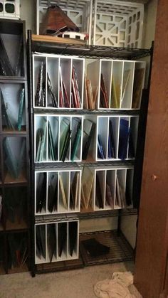 the shelves are filled with different types of papers and folders in storage bins