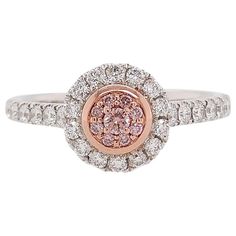 This beautiful ring is featured by Argyle Pink Diamonds and White Diamonds set in PT900 platinum and 18 Karat pink gold. It holds connotations of romance and would be a spectacular gift that can be worn with both daytime and evening looks. - Round Brilliant-Cut Argyle Pink Diamonds total 0.07 carat - Round Brilliant-Cut White Diamonds total 0.36 carat (color E-F, clarity VVS-VS) - Made of Platinum and 18K Pink Gold - Ring Size US6 (can be sized upon request) Argyle mine in Western Australia take Formal Pink Diamond Ring In Platinum, Elegant Pink Diamond Ring In Platinum, Elegant Pink Diamond Cluster Ring, Formal Pink Diamond Cluster Ring, Pink Cluster Ring For Formal Occasions, Fine Jewelry Pink Diamond Ring In Platinum, Luxury Pink Rings With Center Stone, Exquisite Pink Rings With Diamond Accents, Pink Cluster Ring With Brilliant Cut