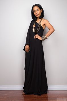 "Black one shoulder dress, Long black kaftan dress, Off shoulder evening dress, black cocktail dress, black party dress, reversible dress PRODUCT SIZE : Free Size * Chest : 40\" will stretch to 44\" * Waist : 40\" will stretch to 44\" * Hips : 40\" will stretch to 44\" * Sleeve length : 23\" * Length : 57\" - 58\" from shoulder to hem (measured when laying flat) MATERIAL : * ITY (polyester jersey) > soft and comfortable to wear, not as slippery as spandex. NOTE : * Model chest : 32\", waist : Bohemian One Shoulder Evening Dress, Bohemian One-shoulder Evening Dress, Black One-shoulder Asymmetrical Dress For Gala, Elegant Black One Shoulder Maxi Dress, Black Floor-length One-shoulder Cocktail Dress, Black Asymmetrical Maxi Dress For Evening, Black One-shoulder Floor-length Party Dress, Black One Shoulder Floor-length Party Dress, Black Floor-length One Shoulder Party Dress