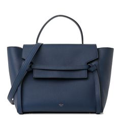 This is an authentic CELINE Grained Calfskin Mini Belt Bag in Deepsea. This chic tote is crafted of drummed calfskin leather in navy with a structured and spacious silhouette. The bag features a leather strap top handle, optional shoulder strap with brass hardware and a front-facing flap that is secured by decorative knotted straps. The facing flap opens to a navy blue suede interior with hanging leather patch pockets. Blue Textured Calf Leather Bag, Classic Blue Calf Leather Shoulder Bag, Elegant Blue Smooth Grain Bags, Chic Blue Calf Leather Bag, Formal Blue Smooth Grain Bag, Classic Blue Shoulder Bag With Smooth Grain, Blue Calf Leather Bag With Detachable Strap, Chic Blue Bag With Smooth Grain, Blue Epsom Leather Top Handle Bag