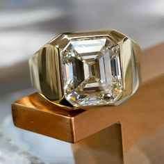 a diamond ring sitting on top of a wooden table