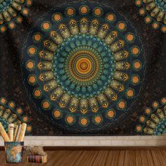 a tapestry hanging on the wall in front of a vase with pencils next to it