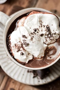 hot chocolate with marshmallows and whipped cream in a cup on a saucer