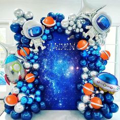 an astronaut themed balloon arch with space theme