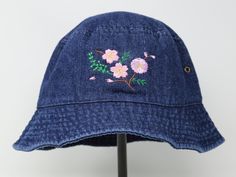 Item: Sakura embroidered bucket hat Material: 100% cotton Size: one size fits most Embroidery: machine embroidered Customization is open, please let me know if you want the design on a different color hat. Free first class shipping, upgradable priority mail service. 30 days return policy, feel confident at your purchase! Embroidered Adjustable Bucket Hat, Spring Embroidered Bucket Hat, Adjustable Embroidered Bucket Hat, Spring Hat With Embroidered Logo And Short Brim, Spring Embroidered Wide Brim Bucket Hat, Embroidered Cotton Bucket Hat With Curved Brim, Casual Embroidered Adjustable Bucket Hat, Spring Wide Brim Bucket Hat With Embroidered Logo, Spring Bucket Hat With Embroidered Logo