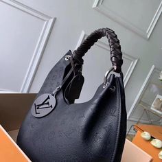 The Carmel hobo bag is a spacious, lightweight style in Mahina calf leather with Monogram perforations. The supple leather and the soft form of the bag combine to make it exceptionally pleasant to carry. Craft details such as the braided handle and LV leather charm add to the sophistication of this model. Detailed Features 35 x 40 x 17 cm (Length x height x width ) Black Mahina perforated calf leather Calf-leather trim Microfiber lining Silver-color hardware Magnetic closure 2 compartments Pocke Sac Louis Vuitton, Tas Bahu, Black Louis Vuitton, Tas Fashion, Black Leather Bags, Virgil Abloh, Somali, Bags Designer Fashion, Vuitton Bag