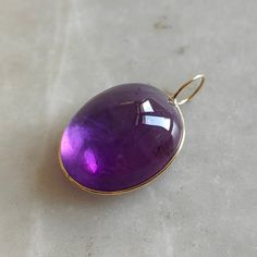 This stunning Pendant is set in 14k Solid Yellow Gold with Natural Purple Amethyst with utmost precision. It is a unique gemstone Pendant for nearly every occasion and is completely hassle-free jewelry. ITEM DETAILS: * Gem: Purple Amethyst * Gem Size: 20x25mm * Gem Shape: Oval Fix Loop * Gem Weight: 41.25 carats * Gold Purity: 14KT  * Gold Weight: 0.47 gram * Total Weight of the Pendant: 8.72 gram The Gold purity is guaranteed and it comes with authentic 14KT gold hallmark. Since my items are ha Elegant Amethyst Cabochon Gemstones, Elegant Cabochon Amethyst Gemstones, Formal Amethyst Oval Cabochon Jewelry, Formal Amethyst Jewelry, Oval Cabochon, Yellow Gold Briolette Gemstones For Formal Occasions, Formal Yellow Gold Briolette Gemstones, Formal Purple Cabochon Gemstones, Polished Amethyst Gemstones For Formal Occasions, Yellow Gold Amethyst Cabochon Ring